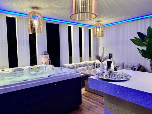 a living room with a large tub with purple lighting at Muthee Luxurious Private Villa in Laganas