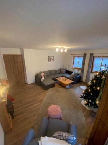 a living room with a christmas tree and a couch at Weber´s Fewo in Graswang