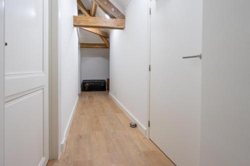 a hallway with white walls and a wooden floor at Château Constance, 19 personnes in La Roche-en-Ardenne