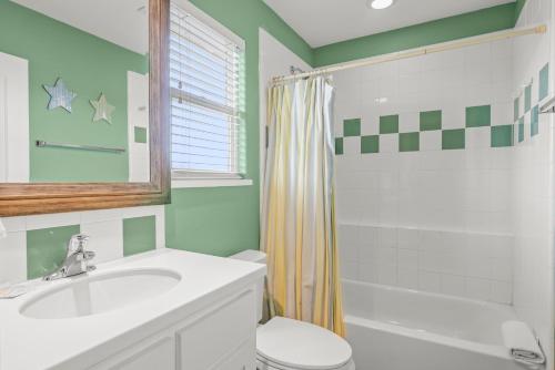 a bathroom with a sink and a toilet and a shower at Friday Life in Port Aransas