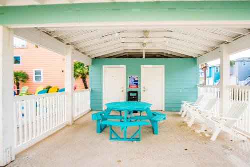a picnic table on the front porch of a beach house at Friday Life in Port Aransas