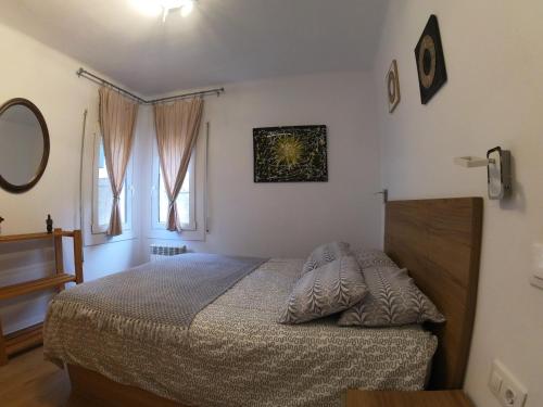 a bedroom with a bed and two windows at Soldeu Paradis Soldeu in Soldeu