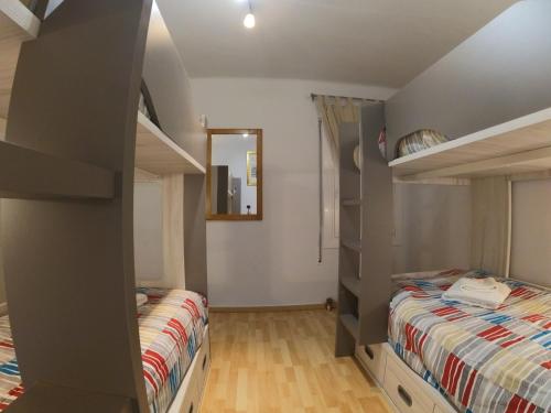 a bedroom with two bunk beds and a mirror at Soldeu Paradis Soldeu in Soldeu