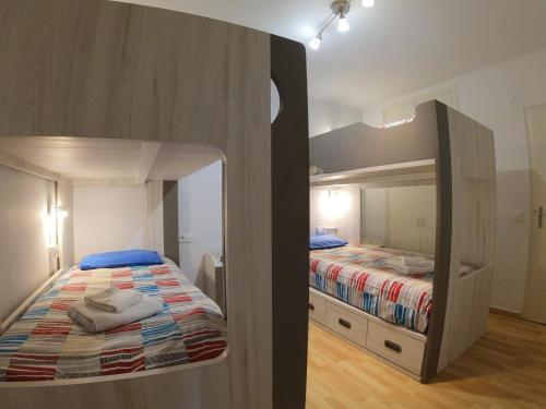 a bedroom with a bunk bed and a mirror at Soldeu Paradis Soldeu in Soldeu