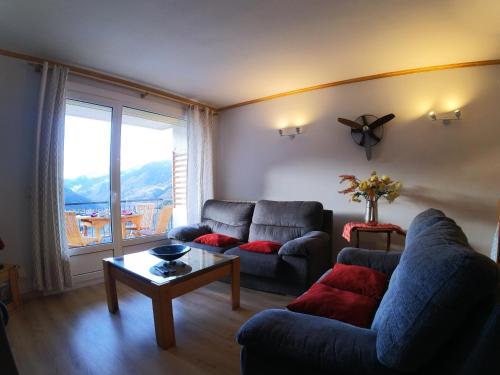 a living room with a couch and a table at Soldeu Paradis Soldeu in Soldeu