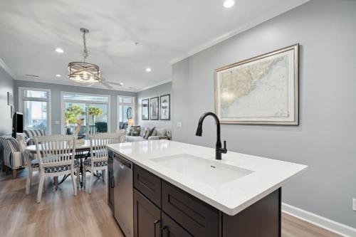 a kitchen with a sink and a dining room at 21 Turtle Bay Carolina Tides in Folly Beach