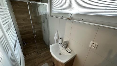 a bathroom with a sink and a shower at Apartment house with sauna and jacuzzi Svätý Kríž 2 in Svätý Kríž