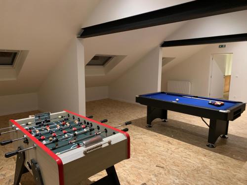 a ping pong table in a room with a pool table at Gîte de Brohimont Vakantiehuis - Cottage - Exclusive Home of Silence - All in in Houyet