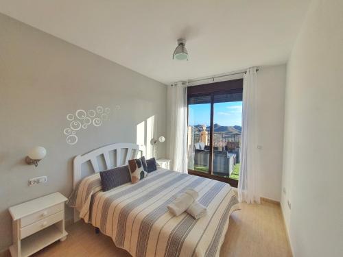 a bedroom with a bed and a large window at Espectaculares vistas con todo confort - by Aloha Palma in Águilas