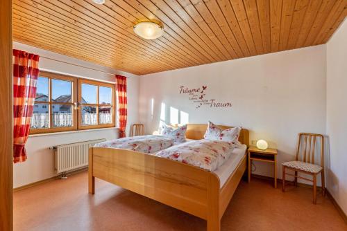 a bedroom with a bed with a wooden ceiling at Ferienhaus Toni in Hohenstein
