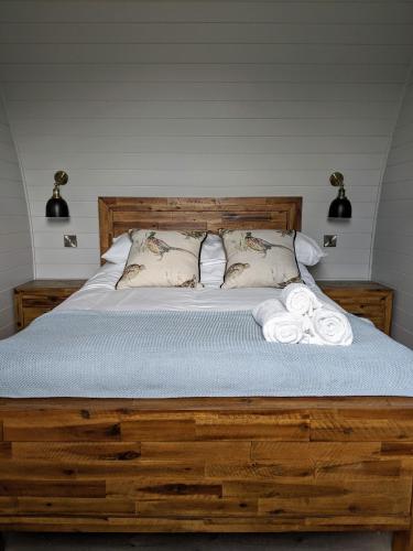 a bedroom with a bed with two towels on it at Wolds Wine Estate in Normanton on the Wolds