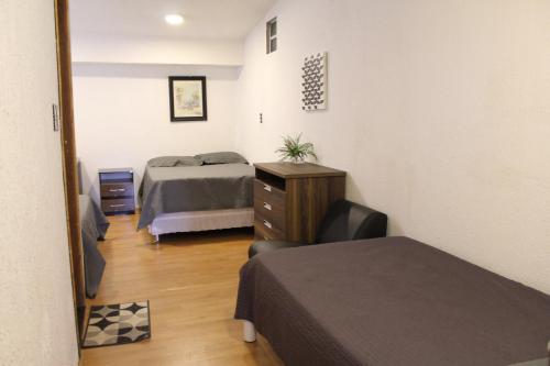 a bedroom with two beds and a mirror at AP 40- Apart OH in Ciudad del Este