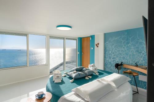 a bedroom with a bed with a view of the ocean at Laguna Blu - Resort Villa overlooking the sea on the Amalfi Coast in Vietri