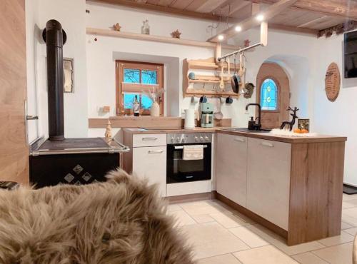 a kitchen with a stove and an oven in it at s'Zuhaus in Kirchbichl