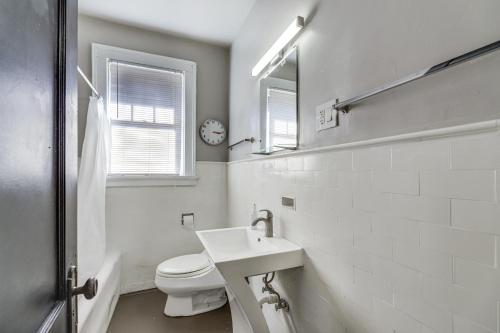 a white bathroom with a toilet and a sink at Cozy Cincinnati Vacation Rental, Walk to Park! in Cincinnati