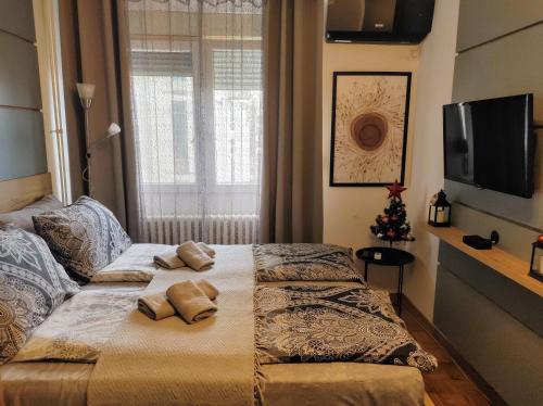 a bedroom with a bed with two pillows on it at Studio Sunset in Voždovac