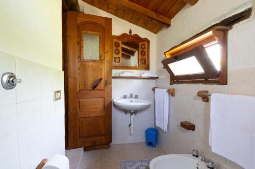 Villa L'Oliveto في أوليينا: حمام مع حوض ومرحاض
