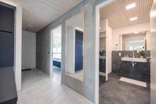 a bathroom with a mirror and a sink at Purer Genuss - Garten und Alpe in Owingen