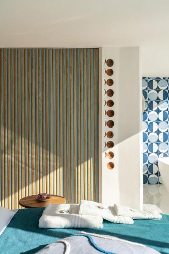 a bedroom with a bed with towels on it at Laguna Blu - Resort Villa overlooking the sea on the Amalfi Coast in Vietri sul Mare