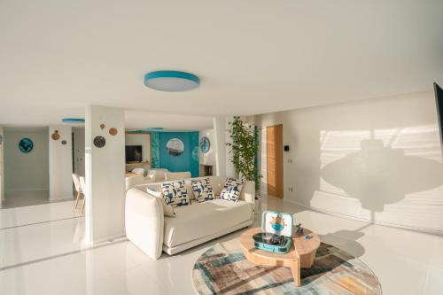 a living room with a couch and a table at Laguna Blu - Resort Villa overlooking the sea on the Amalfi Coast in Vietri sul Mare
