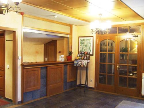 a kitchen with wooden cabinets and a bar in a room at Hotel Turrull in Vielha