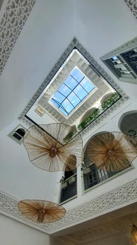 three umbrellas hanging from a ceiling in a room at M-17 Riad & Spa in Marrakesh