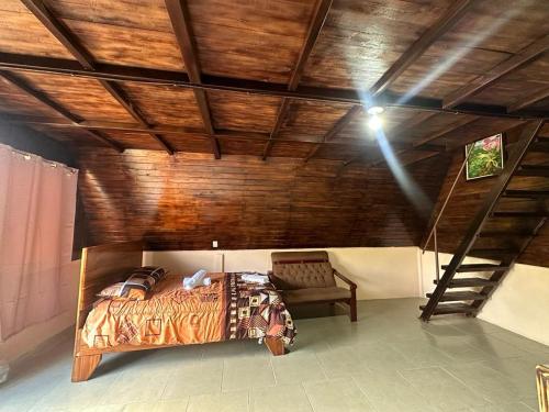 a bedroom with a bed and a wooden ceiling at Bungalows Tenorio Montand Lodge in San Rafael