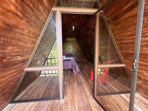 an inside view of a wooden cabin with glass doors at Bungalows Tenorio Montand Lodge in San Rafael