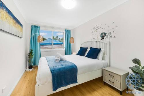 a bedroom with a white bed and a window at Hurstville 2Br Granny flat near Shopping & Train in Sydney