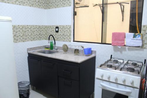 a kitchen with a sink and a stove at AP 80- Apart OH in Ciudad del Este