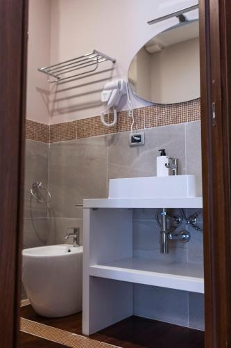 a bathroom with a sink and a bath tub at Affittacamere Le Dimore del Riccio in Foggia