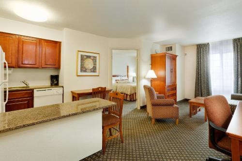 a hotel room with a kitchen and a living room at Staybridge Suites Allentown Airport Lehigh Valley by IHG in Allentown