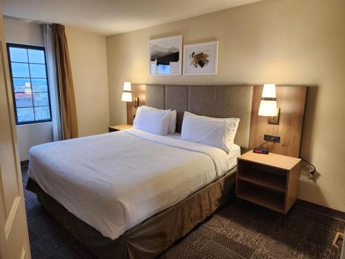 a hotel room with a large bed and two lamps at Staybridge Suites Allentown Airport Lehigh Valley by IHG in Allentown
