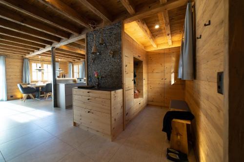 a large room with a kitchen and a dining room at Chalet Gamserrugg in Wildhaus