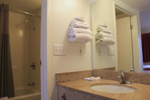 a bathroom with a sink and a mirror and towels at Motel 6-Enfield, CT - Hartford in Enfield