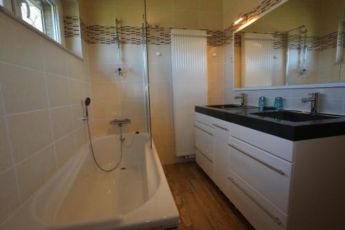 a bathroom with a sink and a shower and a tub at Gîte du Baroudeur in Spa