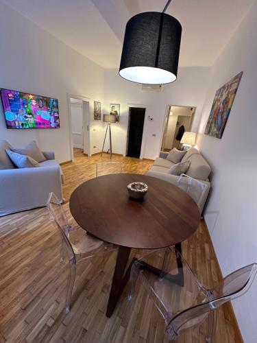 a living room with a table and a couch at House of the Sun in Trastevere in Rome