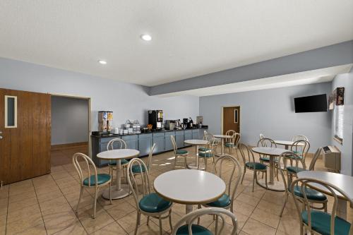 a room with tables and chairs and a kitchen at Red Lion Inn & Suites Gretna - Omaha SW in Gretna