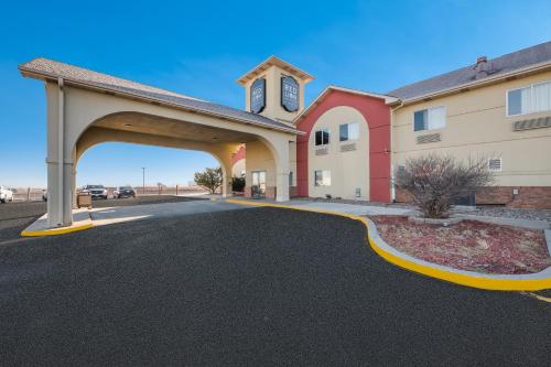 a building with an archway in a parking lot at Red Lion Inn & Suites Gretna - Omaha SW in Gretna