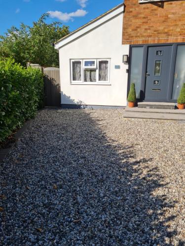 a house with a gravel driveway at 1 Bed Annex 2 mins from Harlow Mill train station in Harlow