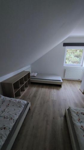 an empty room with two beds and a window at Dům Boubín in Vimperk
