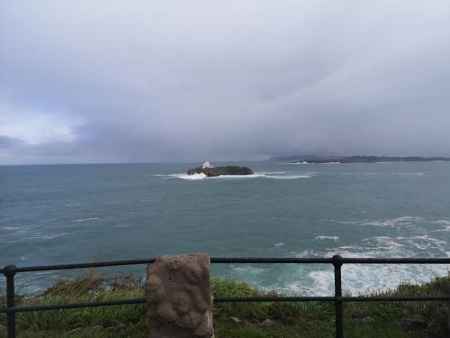 an island in the ocean with a fence at Hostel de las Facultades in Santander