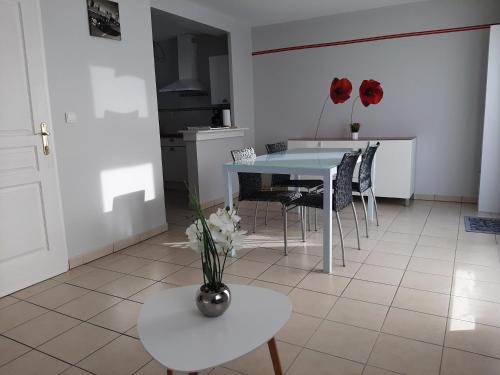 uma cozinha e sala de jantar com mesa e cadeiras em Gîte Cap Goéland - Maison chaleureuse au cœur du site des 2 Caps em Audinghen