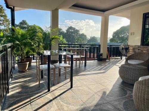 a patio with a table and chairs on a balcony at Namal Apartelle - Free Scooter & GYM access in El Nido