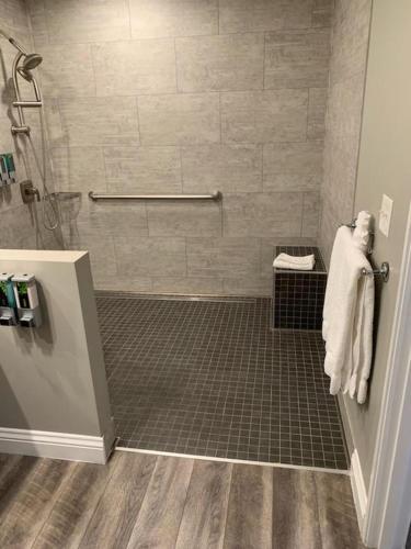 a bathroom with a shower with a tiled floor at Big Bear Frontier in Big Bear Lake