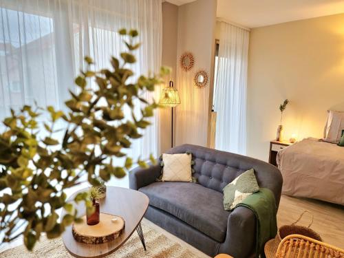 a living room with a couch and a christmas tree at Résidence de Maisons-Laffitte in Maisons-Laffitte