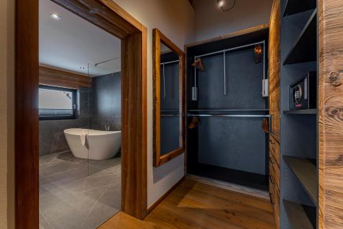 a bathroom with a tub and a sink at Chalet VIE in Viehhofen