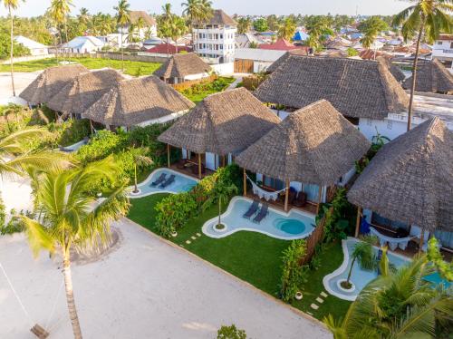 an aerial view of a resort with thatched umbrellas at Safaya Luxury Villas - Adults only in Nungwi