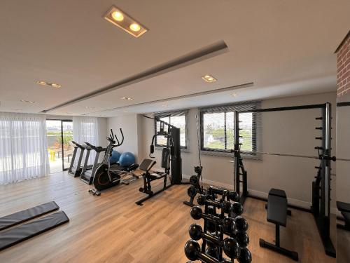 a gym with several treadmills and exercise equipment at Easy Life Campus PUC by Xtay in Curitiba