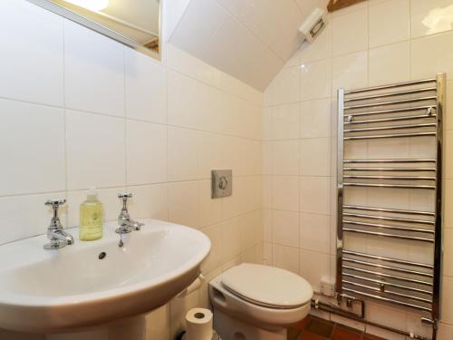 a bathroom with a sink and a toilet at Stable Cottage in Moreton in Marsh